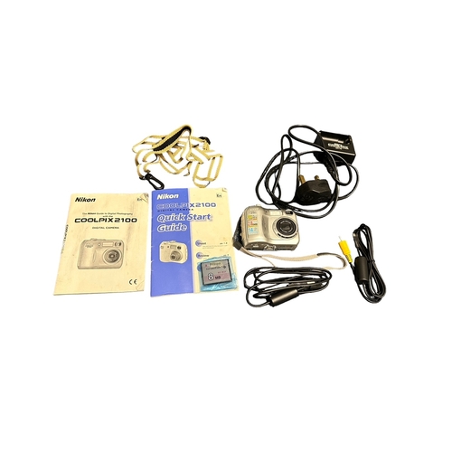 79 - 2x Digital Cameras. 1x Nikon Coolpix 2100 with original box, instruction booklet, charger, AV leads,... 