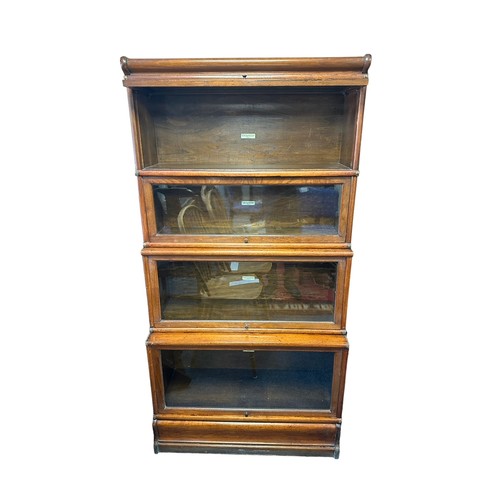 447 - An oak four section Globe Wernicke sectional bookcase with lift up glass fronts, also plinth base an... 