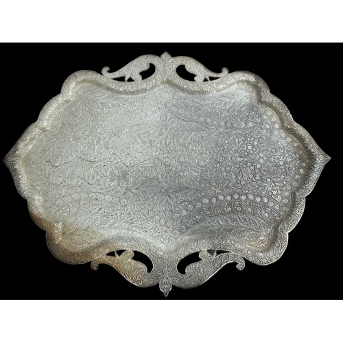 198 - A large,  unusually shaped and ornate white metal platter. Approx 58cm in length. Some tarnishing.