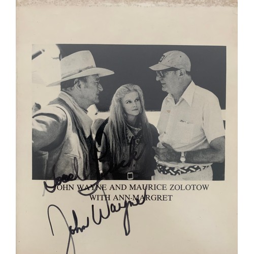 261 - John Wayne (1907-1979) – A framed black and white photograph signed by John Wayne in black ink “Good... 