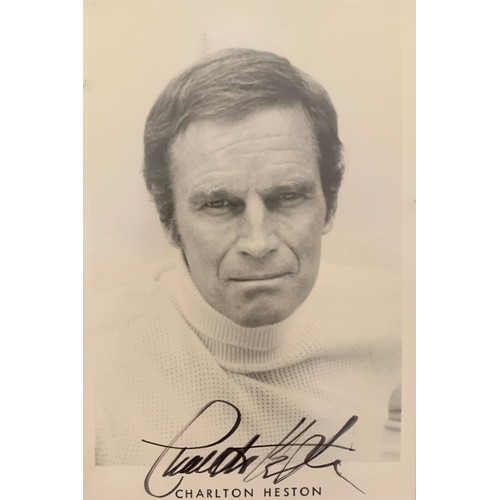 257 - Charlton Heston (1923-2008) – A framed black and white photograph signed by Charlton Heston in black... 