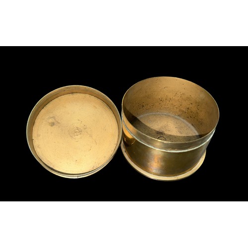 128 - Trench Art lidded Tobacco box made from an ammunition shell. Diameter 11cm.