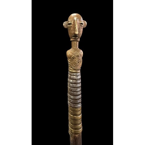 192A - African spear, small shield shaped blade, twisted metal grip, wooden shaft with metal figural head t... 