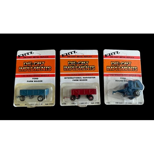 131 - Ertl 1/64th scale Farm implements, mint in excellent carded blisters, with wagons, ploughs etc. 48 h... 