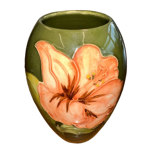 195 - Moorcroft – A Moorcroft Hibiscus pattern small vase, stamped Moorcroft to base. Height 13.5cm.