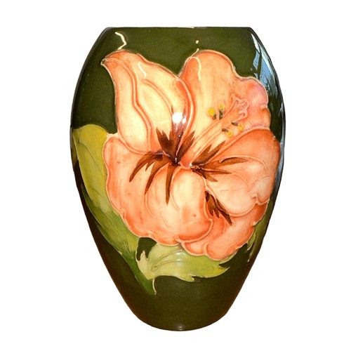 195 - Moorcroft – A Moorcroft Hibiscus pattern small vase, stamped Moorcroft to base. Height 13.5cm.