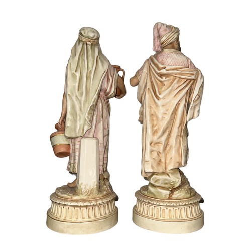 308 - Royal Dux, Pair of Arabian Figurines to include; Arabian Water Carrier figurine, model No. 81. Appea... 