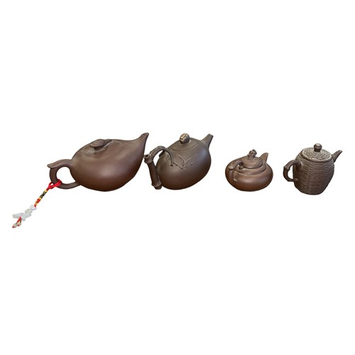 297 - Four Oriental Terracotta Teapots with varying designs & sizes, to include; bamboo handle, thatched b... 