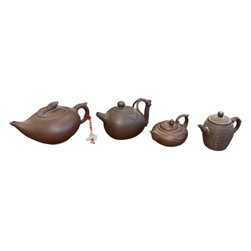 297 - Four Oriental Terracotta Teapots with varying designs & sizes, to include; bamboo handle, thatched b... 