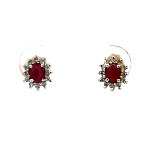 21 - A pair of ruby and diamond cluster earrings. Set in hallmarked 9ct white and yellow gold.

Please se... 