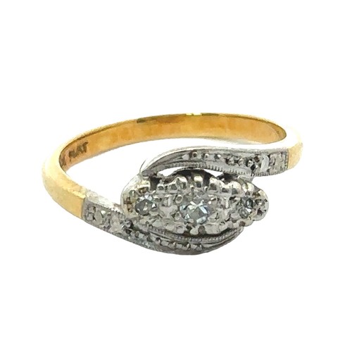 35 - An early 20th century ring stamped '18ct gold and Plat' and  set with three diamonds. Size I. Weight... 