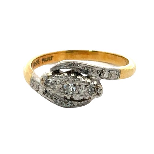 35 - An early 20th century ring stamped '18ct gold and Plat' and  set with three diamonds. Size I. Weight... 