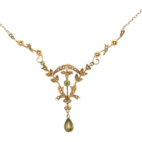 28 - An Edwardian peridot and seed pearl pendant necklace stamped 14K on chain stamped 9ct. Overall lengt... 