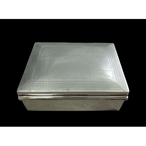 147 - A George V rectangular silver box with wooden lining.  Lid with geometric designed border. By S. Bla... 