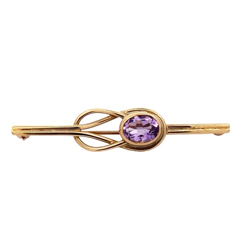 10 - A 9ct gold bar brooch with an amethyst set in a knot design. 48mm in length. Weight 3.42g.
Please se... 