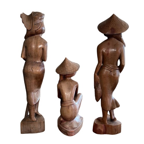 327 - Five Balinese carved wooden female figures. The two standing figures approx. 59cm tall and the kneel... 