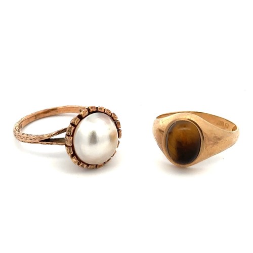 53 - Two 9ct gold rings.  One set with a tiger's eye cabochon, size P - shank misshapen with some nicks a... 