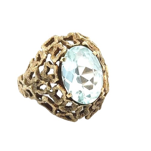 55 - An aquamarine ring with a textured effect setting, stamped 585, size P. Aquamarine approx 14mm x 10m... 