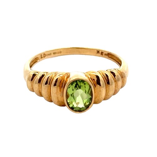 56 - An oval peridot 9ct gold ring, size Q. Weight 2.58g.

Please see the buyer's terms and conditions fo... 