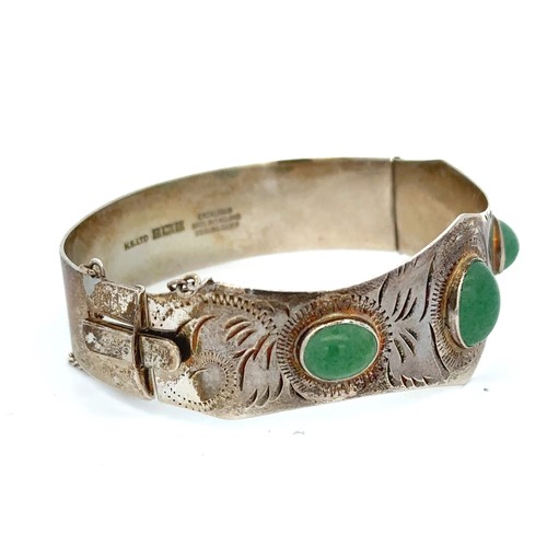 9 - A silver hinged bangle set with three aventurine quartzes. Birmingham hallmarks.
Please see the buye... 