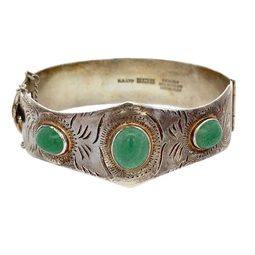 9 - A silver hinged bangle set with three aventurine quartzes. Birmingham hallmarks.
Please see the buye... 