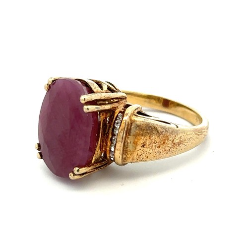 5 - A large ruby and silver gilt ring with white stone shoulders.  stamped 925. Size O. Ruby is treated ... 