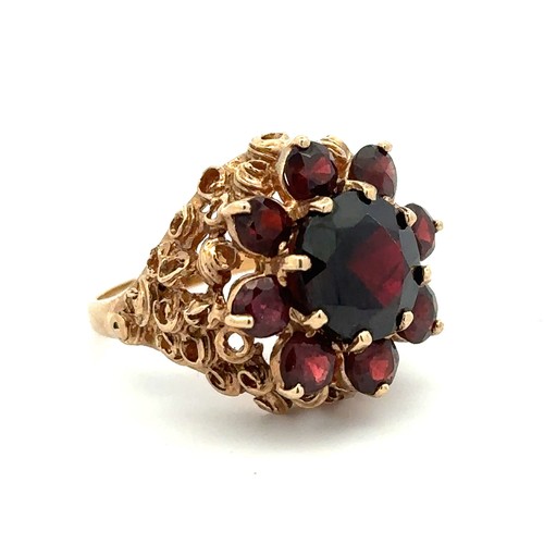 33 - A garnet cluster ring set in 9ct gold, Birmingham hallmarks. Size N. Weight 7.58g.

Please see the b... 