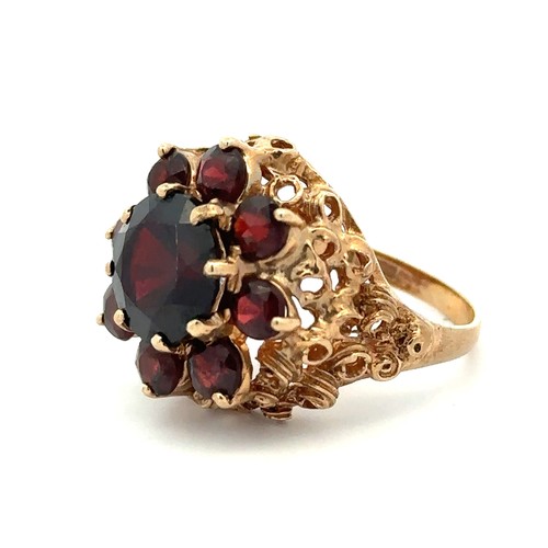 33 - A garnet cluster ring set in 9ct gold, Birmingham hallmarks. Size N. Weight 7.58g.

Please see the b... 