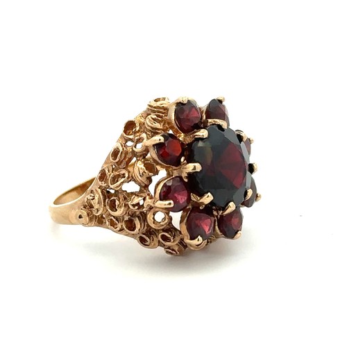 33 - A garnet cluster ring set in 9ct gold, Birmingham hallmarks. Size N. Weight 7.58g.

Please see the b... 