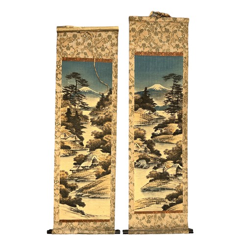 294 - Pair of Japanese hand decorated hanging scrolls, each with a vertical landscape design featuring a w... 