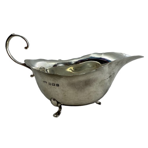 126 - A silver cream jug and tray. Cream jug, 15cm in length, by S Lesser & Sons Ltd, Birmingham 1929. Tra... 