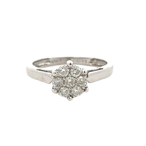 62 - A diamond cluster ring set with seven diamonds, size K. Stamped 18kt and marked as 0.33ct of diamond... 