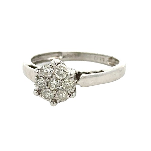 62 - A diamond cluster ring set with seven diamonds, size K. Stamped 18kt and marked as 0.33ct of diamond... 