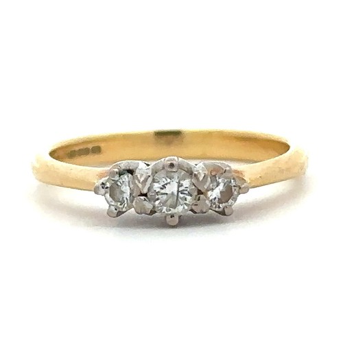 64 - A hallmarked 18ct yellow gold and three stone diamond ring, size J. Diamond weight approx 0.27ct. To... 