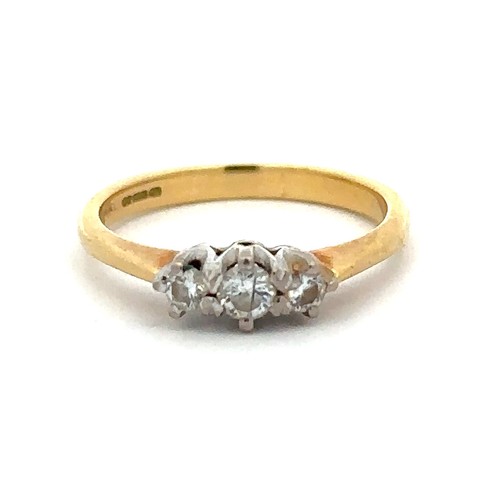 64 - A hallmarked 18ct yellow gold and three stone diamond ring, size J. Diamond weight approx 0.27ct. To... 