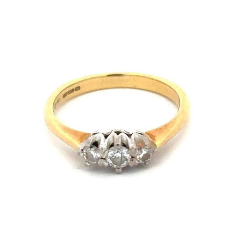 64 - A hallmarked 18ct yellow gold and three stone diamond ring, size J. Diamond weight approx 0.27ct. To... 