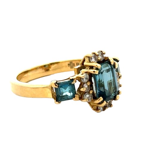 42 - An 18ct gold and London blue topaz and diamond ring, size O. A central emerald cut topaz 8mm x 6mm i... 