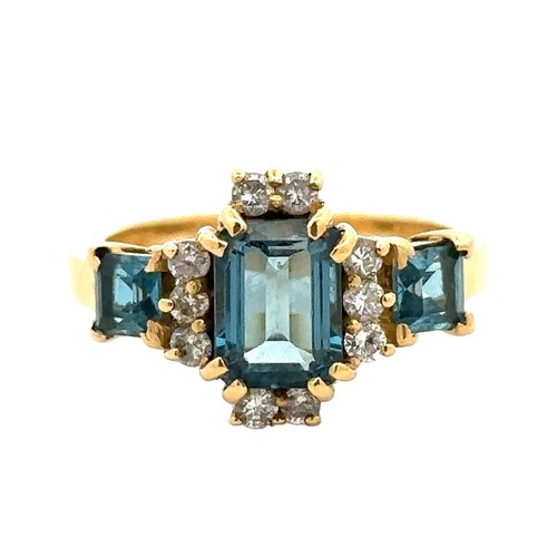 42 - An 18ct gold and London blue topaz and diamond ring, size O. A central emerald cut topaz 8mm x 6mm i... 