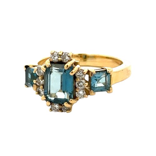 42 - An 18ct gold and London blue topaz and diamond ring, size O. A central emerald cut topaz 8mm x 6mm i... 