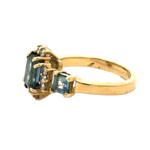 42 - An 18ct gold and London blue topaz and diamond ring, size O. A central emerald cut topaz 8mm x 6mm i... 