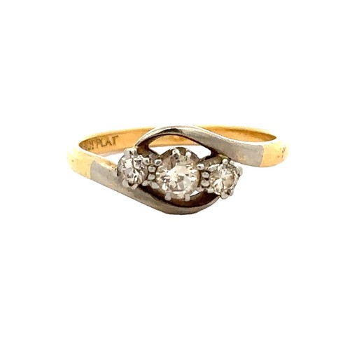 75 - A diamond three stone crossover ring, size K. Weight 2.2g. Stamped '18ct PLAT.'

Please see the buye... 