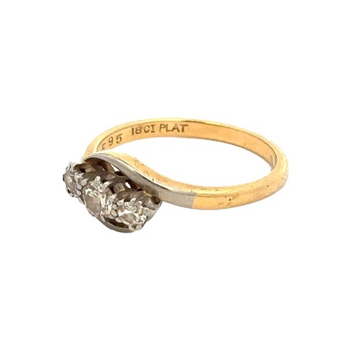 75 - A diamond three stone crossover ring, size K. Weight 2.2g. Stamped '18ct PLAT.'

Please see the buye... 