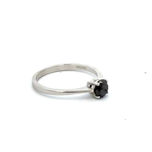 78 - A black single stone ring, size M. Black stone approx 5mm in diameter. Set in 9ct white gold. Weight... 