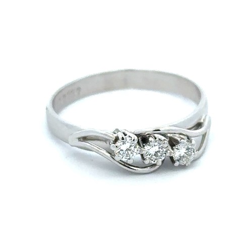 80 - A hallmarked 18ct white gold three stone diamond ring, size Q. Weight 3.31g. Approx 0.24ct diamonds.... 