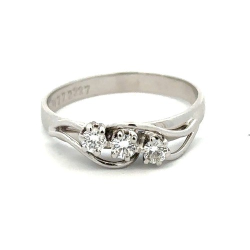 80 - A hallmarked 18ct white gold three stone diamond ring, size Q. Weight 3.31g. Approx 0.24ct diamonds.... 