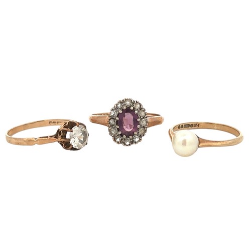 86 - Three 9ct gold rings -  a purple and white paste cluster ring, size O, a pearl ring size L, a white ... 