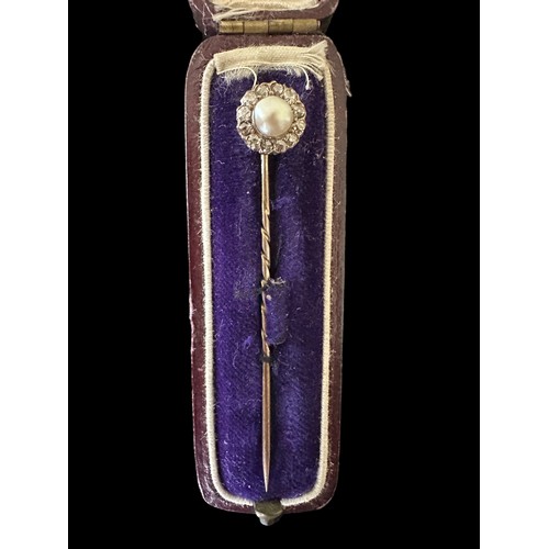 30 - A cased diamond and pearl unmarked yellow metal pin. 63mm in length. Weight 2.17g.

Please see the b... 