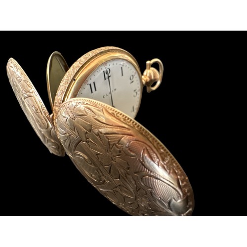 100 - A full hunter gold pocket watch, stamped 585 14K with an engraved case. White enamel dial with Arabi... 