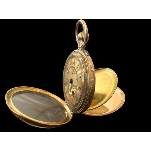 101 - An open face pocket watch stamped 14K. Gold dial with foliate design and Roman numerals hour markers... 