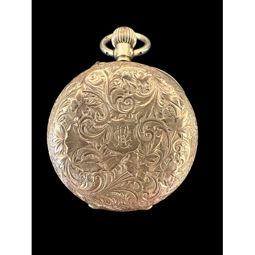 101 - An open face pocket watch stamped 14K. Gold dial with foliate design and Roman numerals hour markers... 